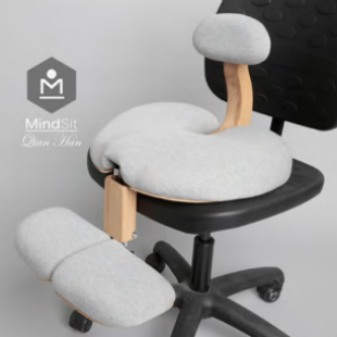 The image shows MindSit, a personalised seat that rests on an existing office chair and aims to the improve posture and mental health of the user.