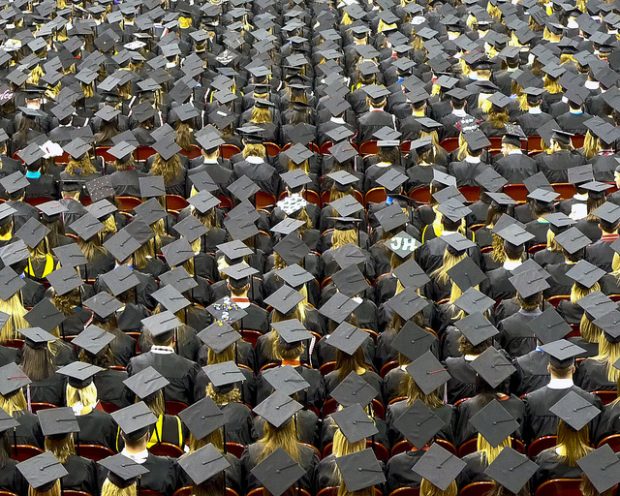 Many students wearing graduation caps from above.