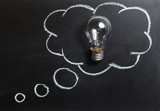 lightbulb surrounded by a thought bubble on a chalk board